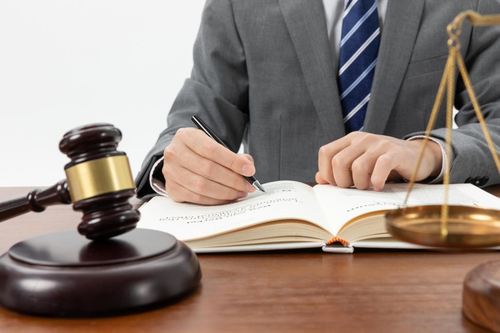 Mortgage advisor in Singapore writing beside a gavel, symbolizing ABSD, legal guidance, and home loan eligibility for co-buyers